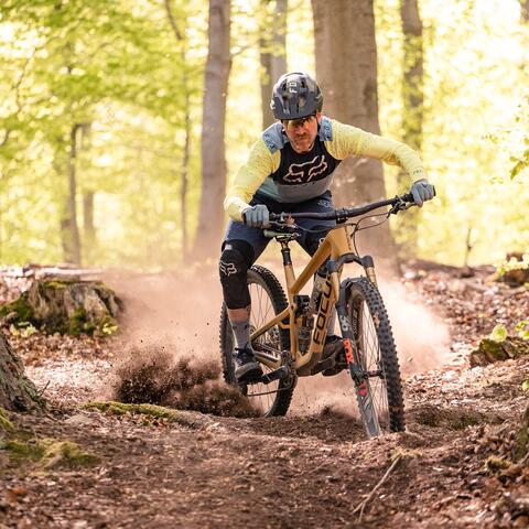 mountain biker slashing dirt